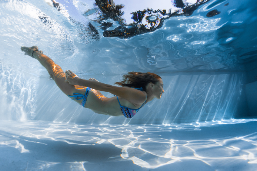 Young woman glides underwater